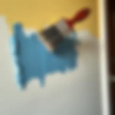 A brush applying acrylic paint on a wall.
