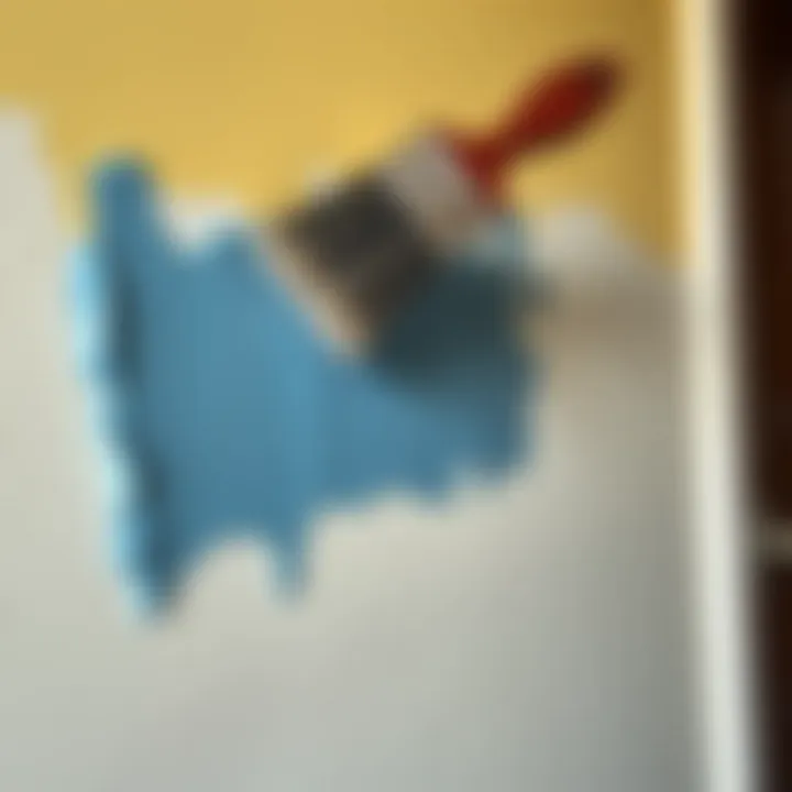 A brush applying acrylic paint on a wall.