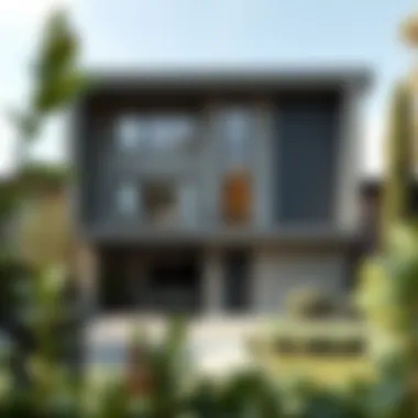 An outdoor view of a contemporary home with a stylish gray facade blending into nature.